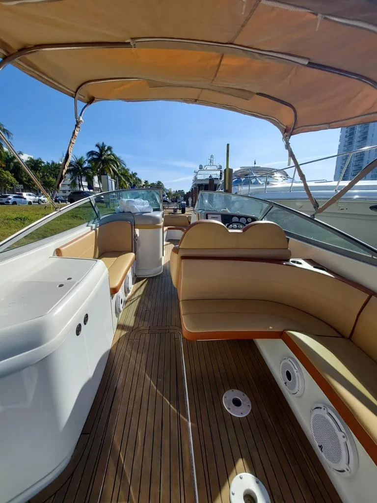 Slide: The Image of 1999 Formula 280 Bowrider with tan interior and wooden deck, docked at marina. - 29