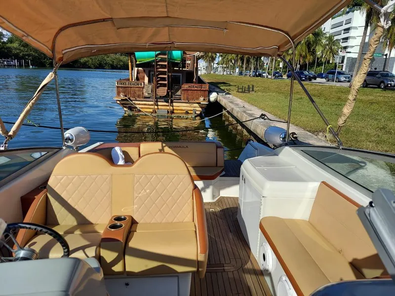 Slide: The Image of 1999 Formula 280 Bowrider boat docked near a wooden houseboat on a sunny day. - 30