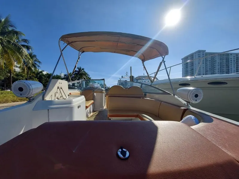 Slide: The Image of 1999 Formula 280 Bowrider boat with canopy, docked under sunny skies. - 31