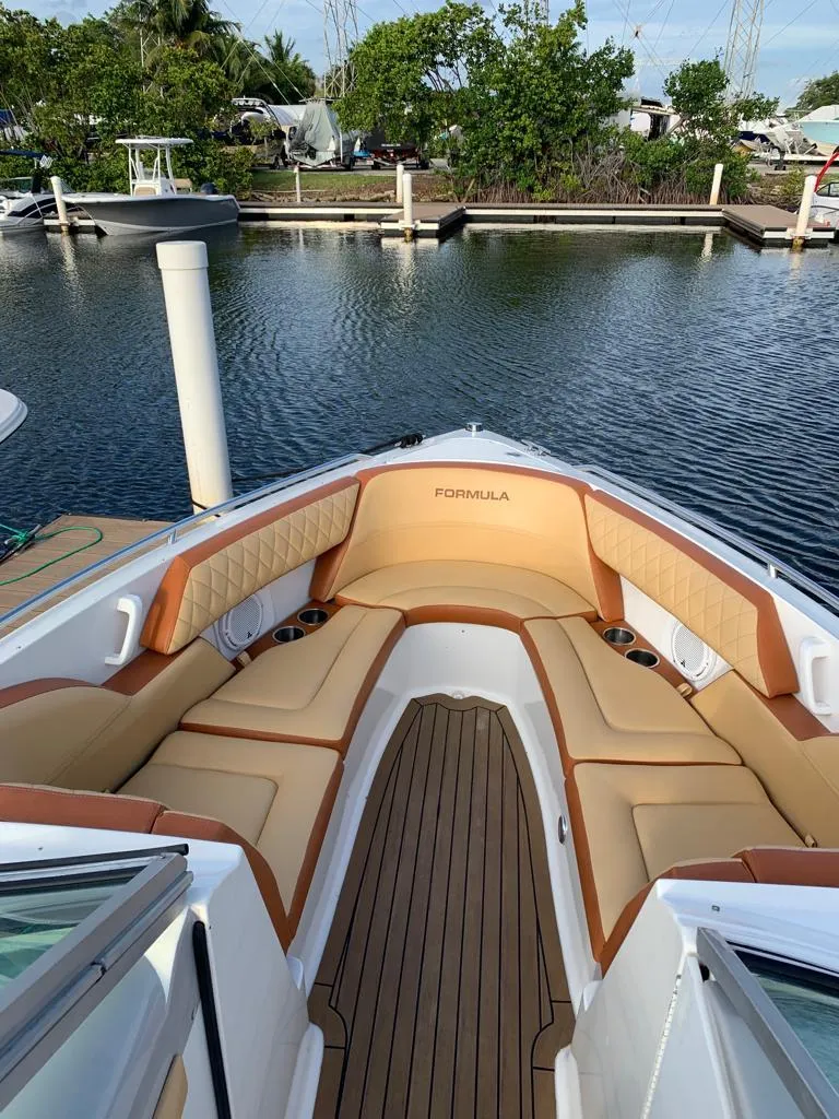Slide: The Image of 1999 Formula 280 Bowrider boat with tan seating docked at marina. - 8