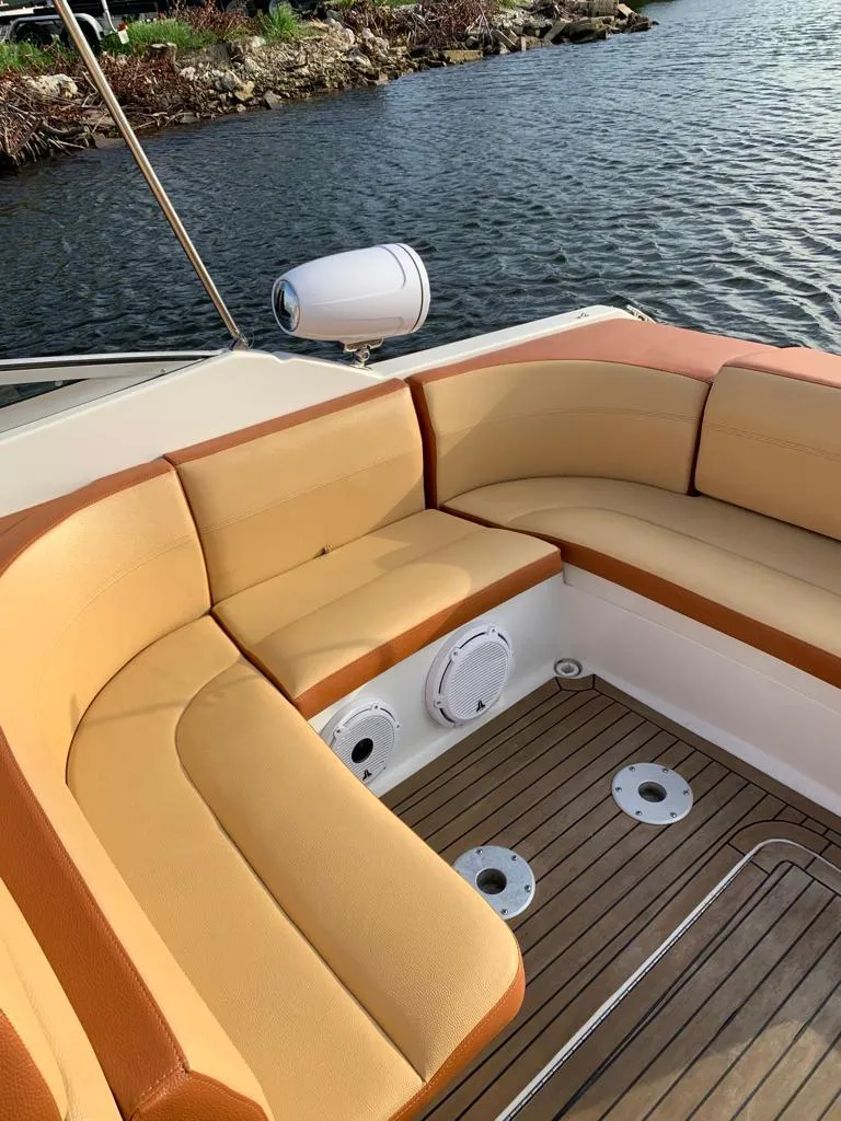 Slide: The Image of 1999 Formula 280 Bowrider with tan leather seating and teak flooring by the water. - 9