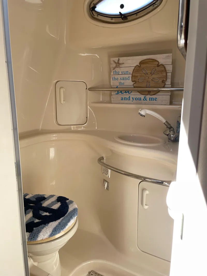 Slide: The Image of 2002 Sea Ray 340 Sundancer bathroom with sink, toilet, and nautical decor. - 16