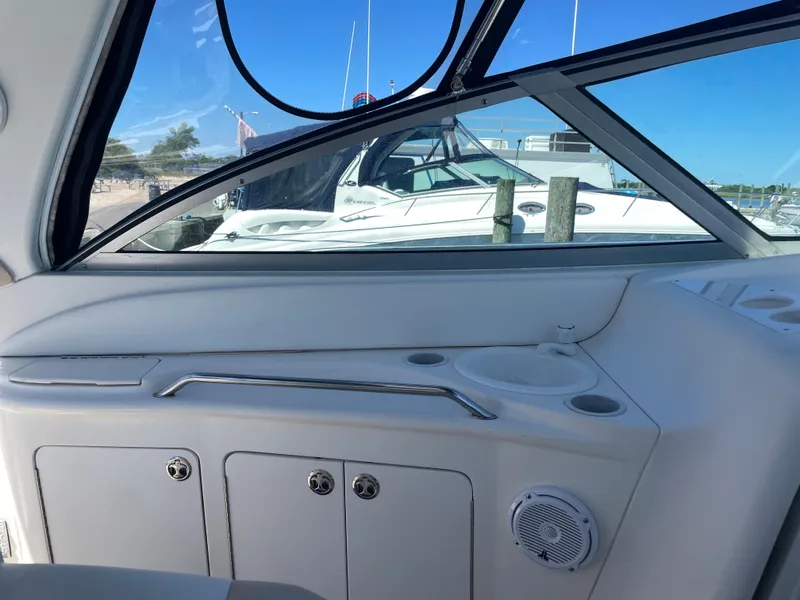 Slide: The Image of Interior view of a 2002 Sea Ray 340 Sundancer boat with docked boats outside. - 3