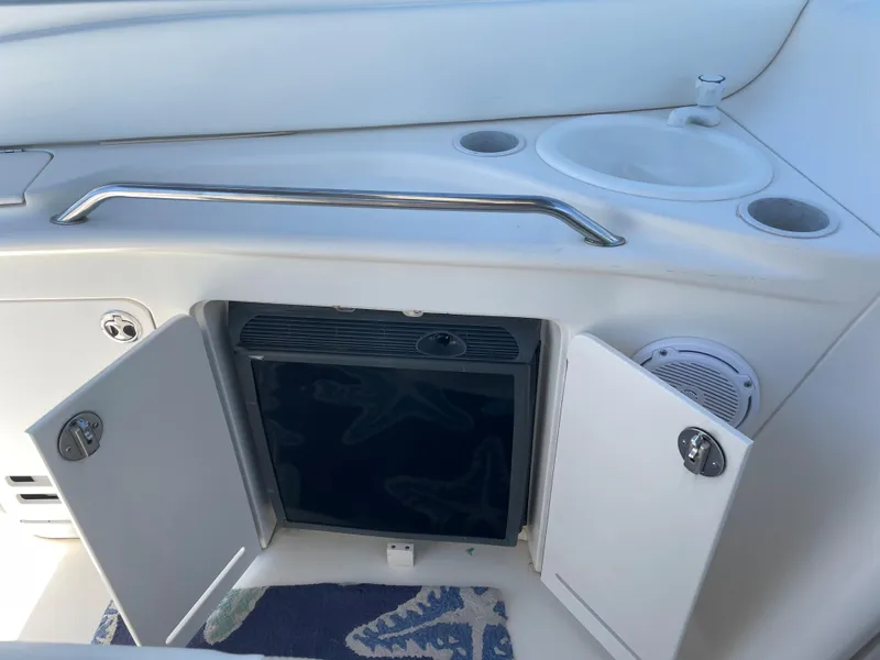 Slide: The Image of 2002 Sea Ray 340 Sundancer boat kitchenette with mini fridge and sink. - 6