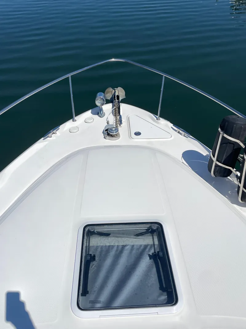 Slide: The Image of 2002 Sea Ray 340 Sundancer bow view on calm water. - 7