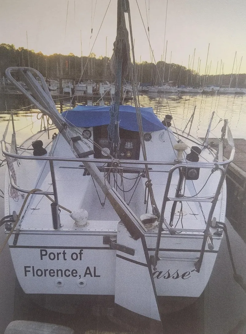 Slide: The Image of 1980 J Boats 30 docked at Port of Florence, AL, with serene water backdrop. - 2