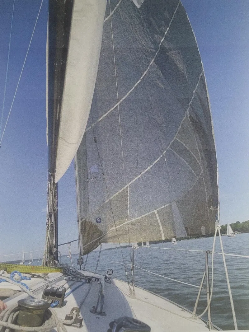 Slide: The Image of 1980 J Boats 30 sailing on calm waters under clear blue sky. - 3
