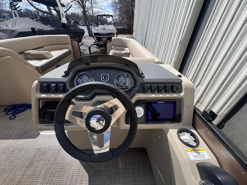 Slide: The Image of Steering console of 2022 Sweetwater SW 2286 C pontoon boat with gauges and controls. - 10