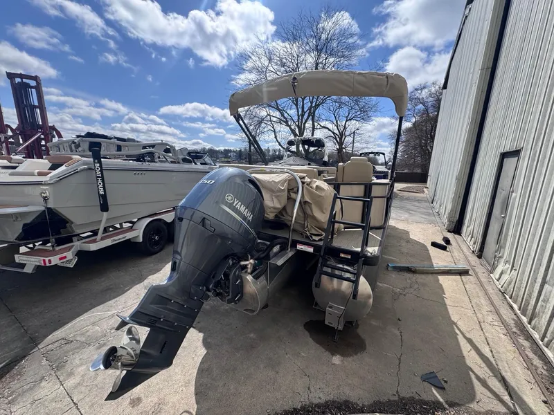 Slide: The Image of 2022 Sweetwater SW 2286 C pontoon boat with Yamaha outboard motor, parked outdoors. - 13