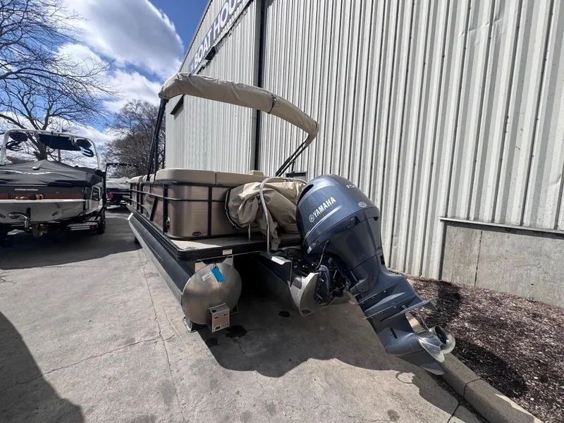 Slide: The Image of 2022 Sweetwater SW 2286 C pontoon boat with Yamaha outboard motor, parked outdoors. - 14