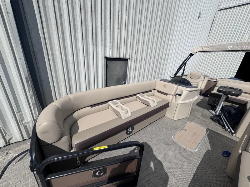 Slide: The Image of 2022 Sweetwater SW 2286 C pontoon boat interior with beige seating and cup holders. - 5