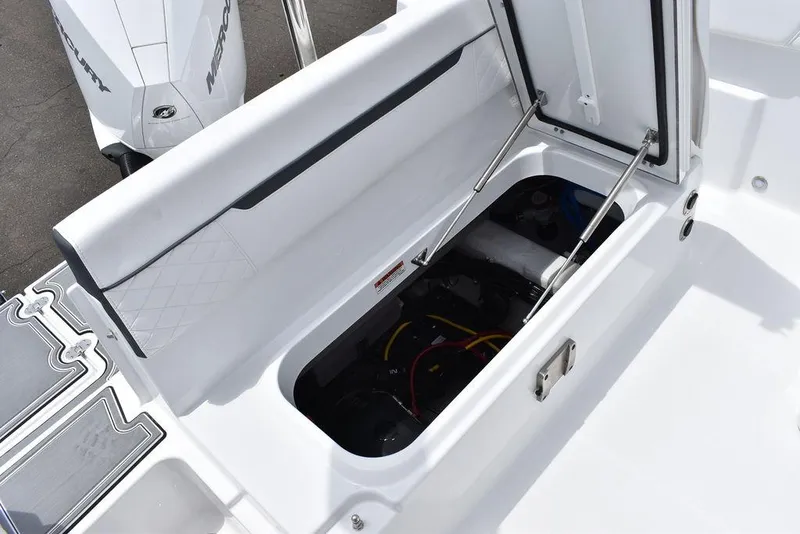 Slide: The Image of 2023 Blackfin 232 DC storage compartment with open hatch and visible engine components. - 20