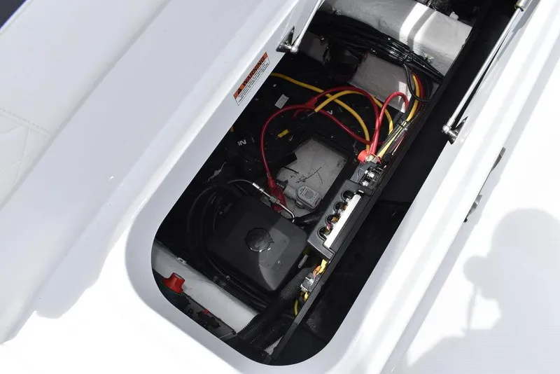 Slide: The Image of 2023 Blackfin 232 DC boat electrical compartment with wiring and battery. - 21