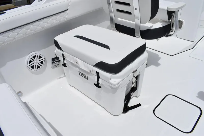 Slide: The Image of 2023 Blackfin 232 DC boat interior with Yeti cooler and cushioned seat. - 24