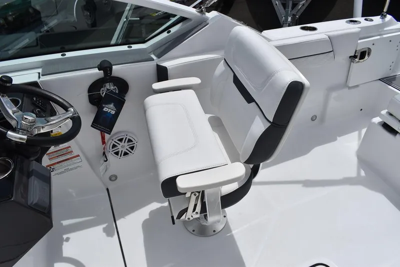 Slide: The Image of 2023 Blackfin 232 DC boat cockpit with white captain's chair and steering wheel. - 25