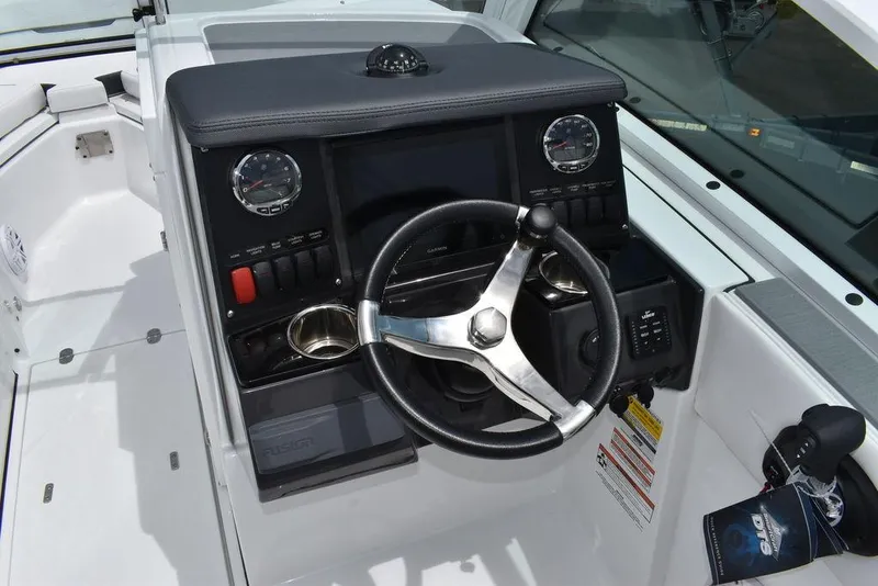 Slide: The Image of 2023 Blackfin 232 DC boat dashboard with steering wheel and control panel. - 29