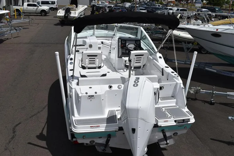 Slide: The Image of 2023 Blackfin 232 DC boat with outboard motor, docked in a marina. - 3