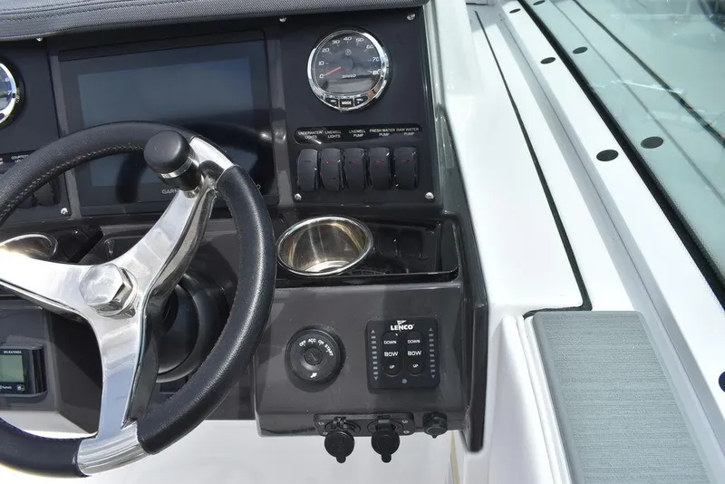 Slide: The Image of 2023 Blackfin 232 DC boat dashboard with steering wheel and control panel. - 34