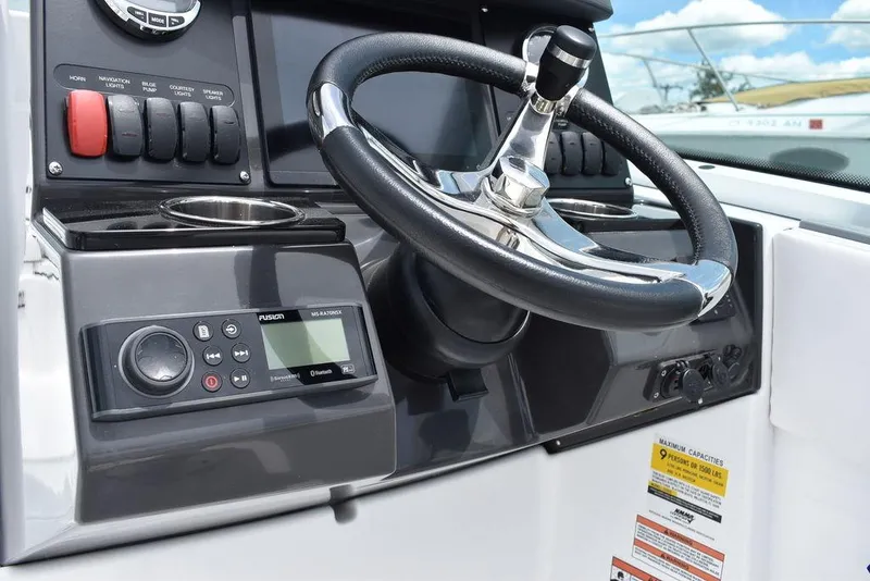 Slide: The Image of 2023 Blackfin 232 DC boat dashboard with steering wheel and control panel. - 35