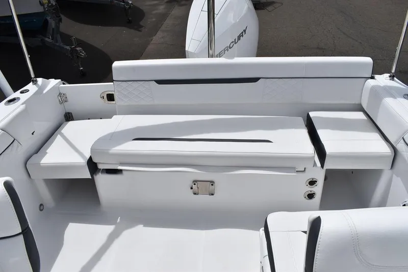 Slide: The Image of 2023 Blackfin 232 DC boat interior with white seating and Mercury engine. - 39