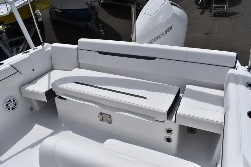 Slide: The Image of 2023 Blackfin 232 DC boat interior with white seating and Mercury engine. - 41