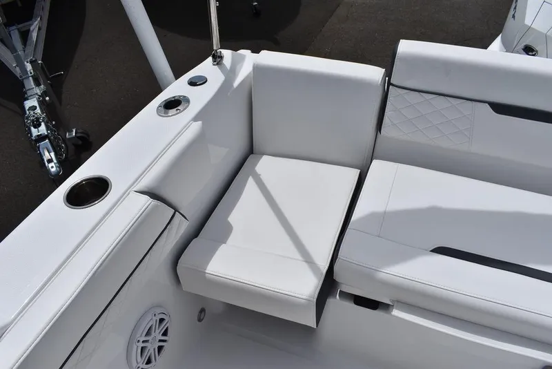 Slide: The Image of 2023 Blackfin 232 DC boat with white cushioned seating and cup holders. - 42