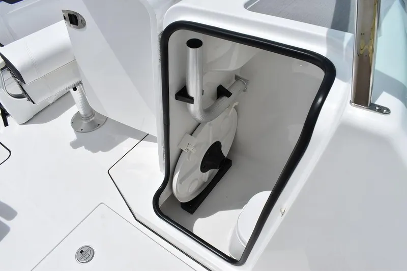 Slide: The Image of 2023 Blackfin 232 DC storage compartment with white interior and mounted equipment. - 45