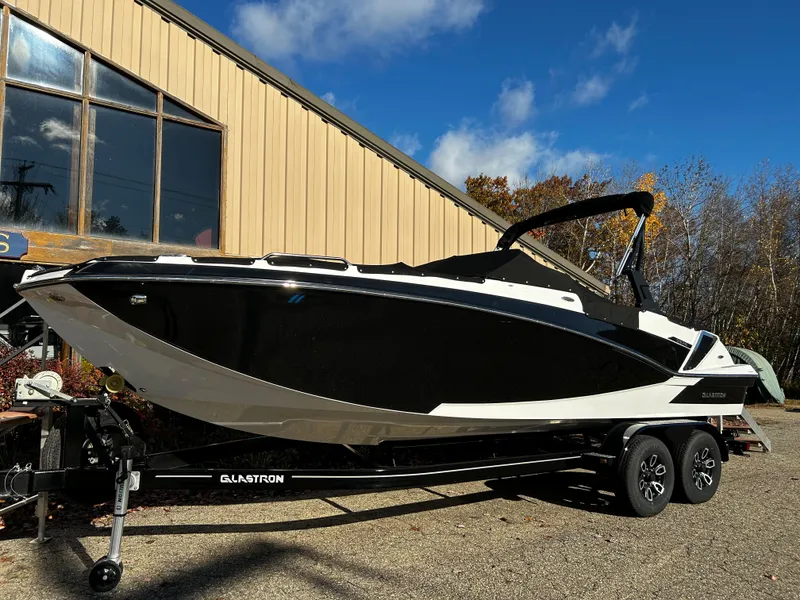Slide: The Image of 2023 Glastron GTD 245 boat on a trailer outside a building. - 0