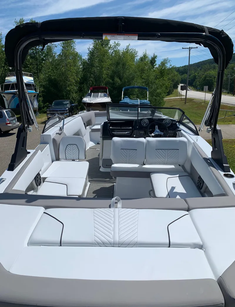 Slide: The Image of 2023 Glastron GTD 245 boat with spacious white seating and modern design. - 16