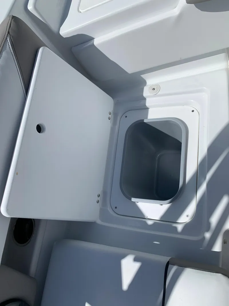 Slide: The Image of 2023 Glastron GTD 245 storage compartment with open lid. - 22