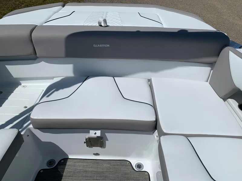 Slide: The Image of 2023 Glastron GTD 245 boat interior seating area with gray and white upholstery. - 24