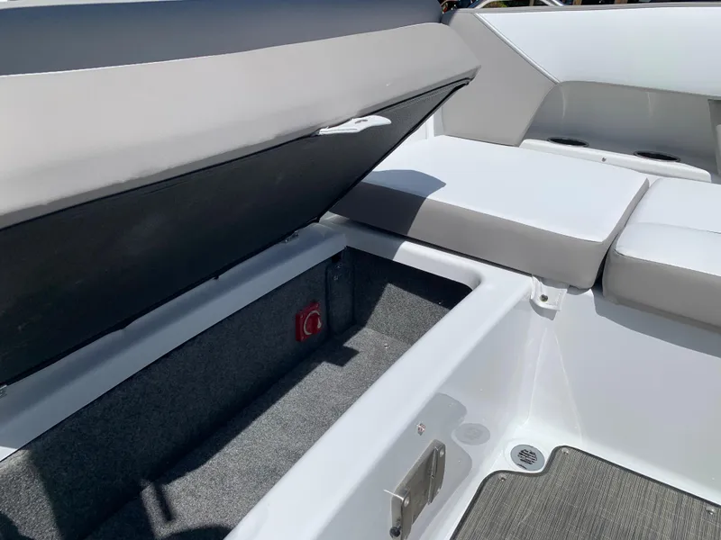 Slide: The Image of 2023 Glastron GTD 245 boat interior storage compartment with cushioned seating. - 26