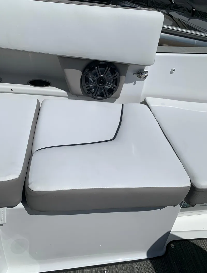 Slide: The Image of 2023 Glastron GTD 245 boat with white cushioned seating and built-in speaker. - 28