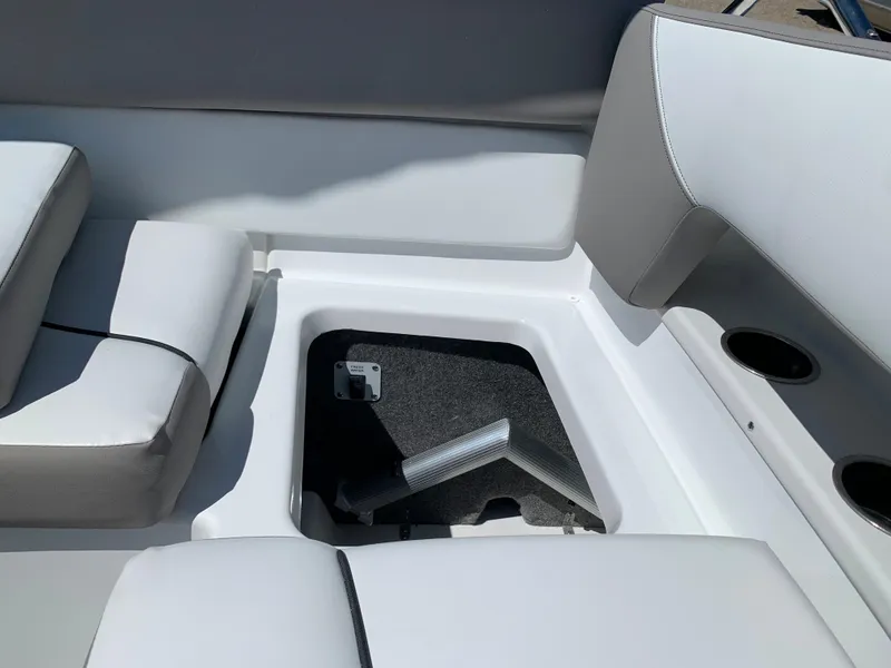 Slide: The Image of 2023 Glastron GTD 245 boat interior storage compartment with cushioned seating. - 29