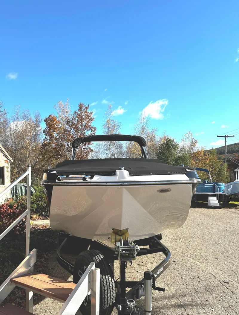 Slide: The Image of 2023 Glastron GTD 245 boat on a trailer in a sunny outdoor setting. - 3