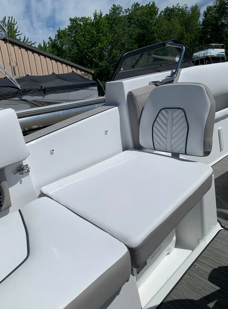 Slide: The Image of 2023 Glastron GTD 245 boat interior seating with white and gray upholstery. - 31