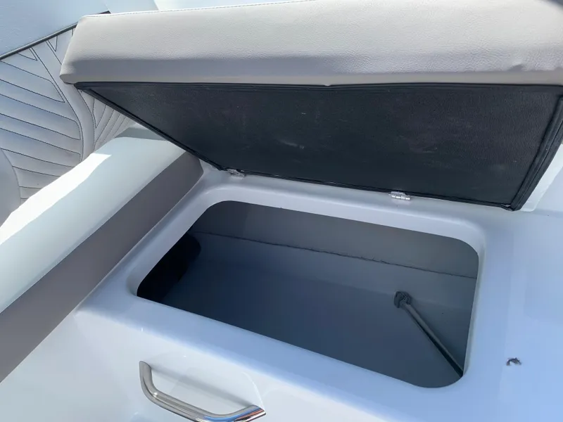 Slide: The Image of 2023 Glastron GTD 245 boat storage compartment with open lid. - 35