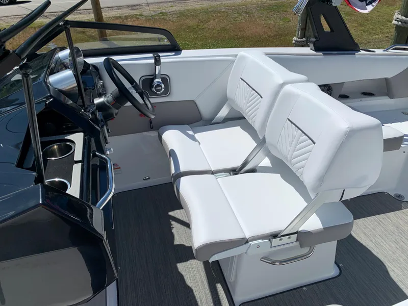 Slide: The Image of 2023 Glastron GTD 245 boat interior with white seats and steering console. - 38