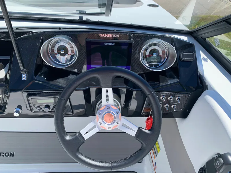 Slide: The Image of 2023 Glastron GTD 245 boat dashboard with steering wheel and instrument panel. - 40