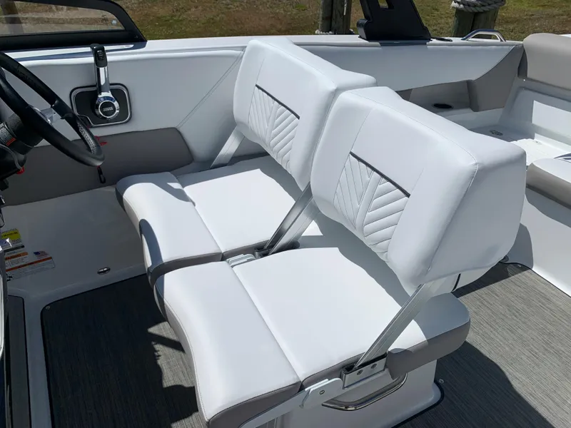 Slide: The Image of 2023 Glastron GTD 245 boat interior with white double seats and steering console. - 43