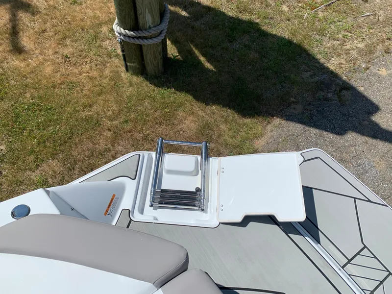 Slide: The Image of 2023 Glastron GTD 245 boat with foldable ladder and deck view. - 9