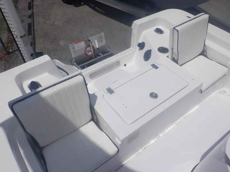 Slide: The Image of 2023 Piranha Casador B2200 boat interior with white cushioned seats and storage compartment. - 10