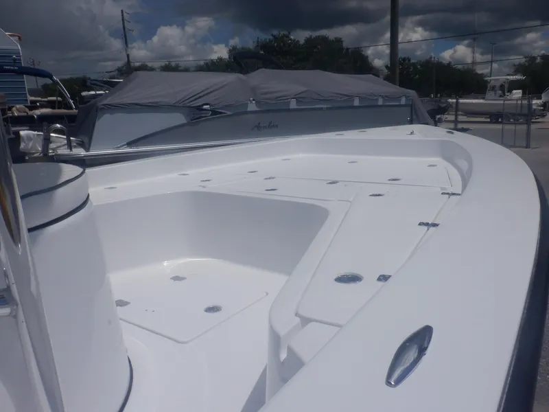 Slide: The Image of 2023 Piranha Casador B2200 boat deck, white, spacious, docked under cloudy sky. - 14