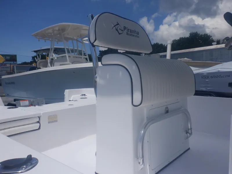 Slide: The Image of 2023 Piranha Casador B2200 boat interior with cushioned seating and storage. - 15