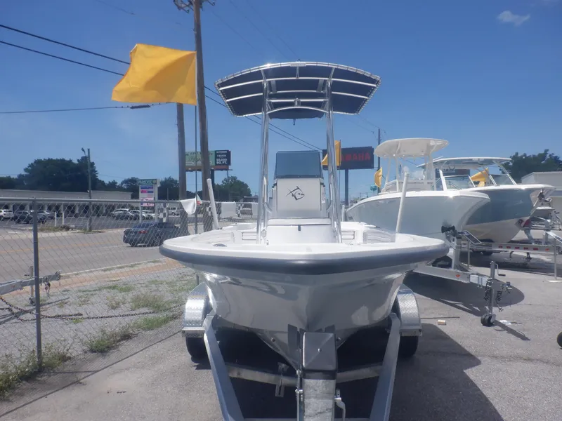 Slide: The Image of 2023 Piranha Casador B2200 boat on trailer, displayed outdoors with yellow flags. - 17