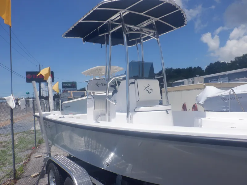 Slide: The Image of 2023 Piranha Casador B2200 boat with T-top on trailer, displayed outdoors. - 18