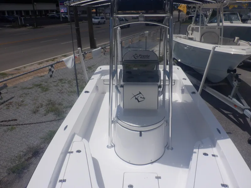 Slide: The Image of 2023 Piranha Casador B2200 center console boat on display at a dealership. - 5