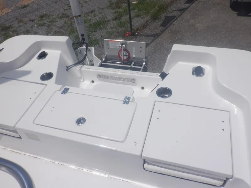 Slide: The Image of 2023 Piranha Casador B2200 boat deck with storage compartments and fishing rod holders. - 6