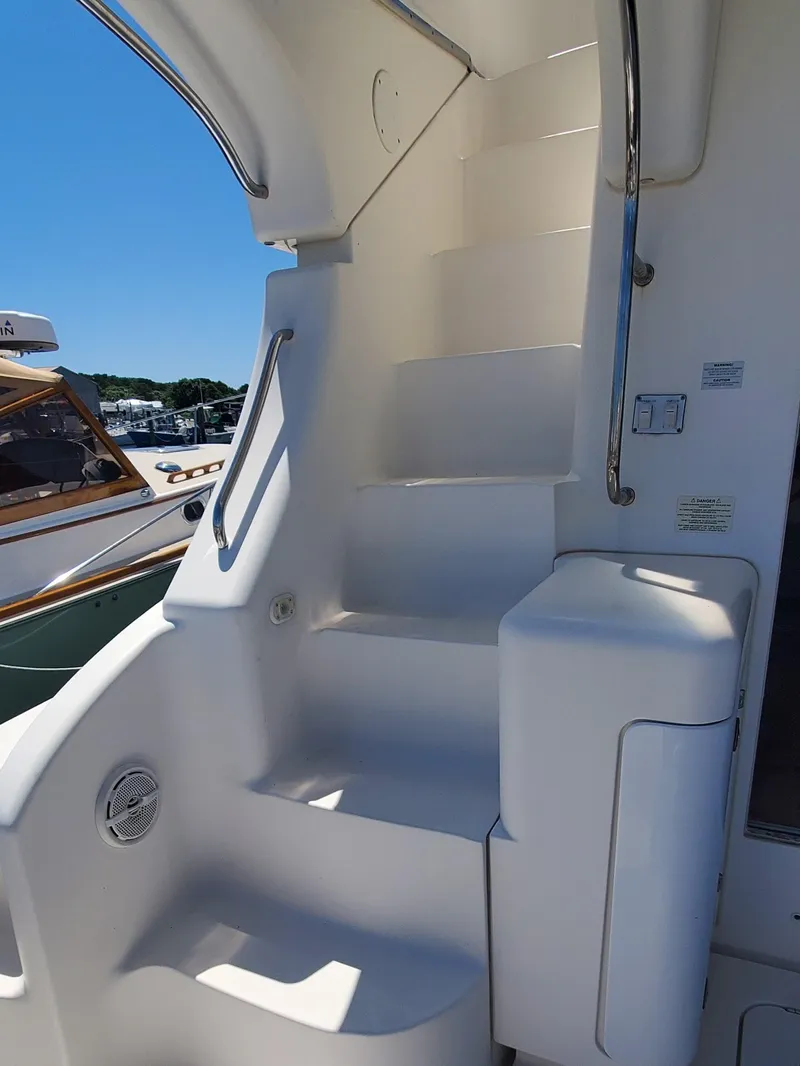 Slide: The Image of Staircase on a 2003 Silverton 38 Convertible yacht, featuring sleek white design. - 10