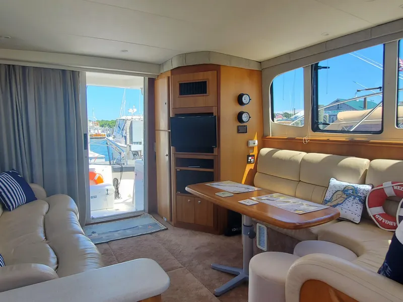 Slide: The Image of Interior of 2003 Silverton 38 Convertible yacht with plush seating and modern amenities. - 16